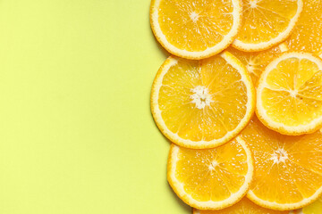 Composition with tasty slices of  orange on green background, closeup