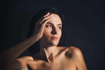 Fototapeta premium Photo of pretty lady look empty space dark color background touch silky face skin