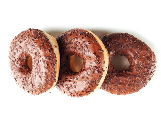 Three chocolate donut with sprinkles on top. The donut is sitting on a white background. Premium...
