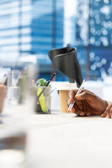 HR worker reviewing candidate, asking questions about qualifications, giving him application form. Close up of applicant writing signature on paperwork after proving enthusiasm for job opportunity
