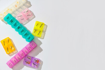 Pill organizers on white background. Top view
