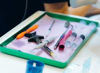 Set of dental instruments in a tray.