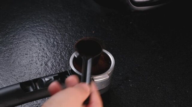 Putting fresh ground coffee in a coffee filter. High quality 4k footage