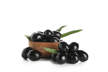Wooden bowl with tasty black olives and leaves on white background