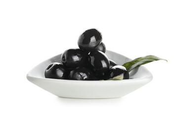 Plate with tasty black olives and leaves on white background