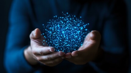 Glowing blue particles floating above cupped hands in dark background, creating magical ethereal effect for technology and innovation concepts.