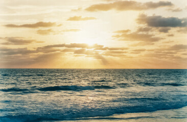 Sun rays breaking through the clouds over the sea