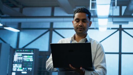 System administrator in data center managing servers, operating systems and software applications. Expert in server hub ensuring networks are secure, up to date, and functioning properly, camera A