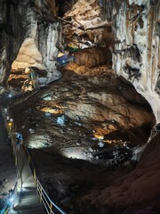 Stunning Cave Interior with Illuminated Pathway and Rock Formations