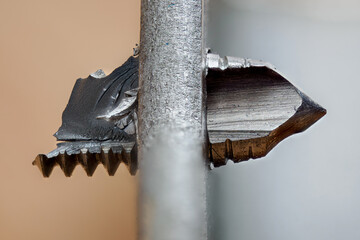 Part of a broken tap in metal material.
