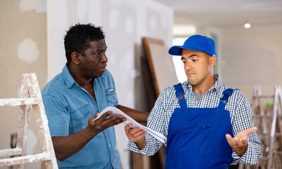Fototapeta premium Owner of apartment expresses dissatisfaction with the work performed by the foreman