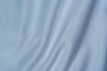 Fototapeta premium Soft white fabric with smooth folds and swirl pattern