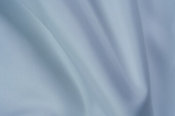 Soft white fabric with smooth folds and swirl pattern