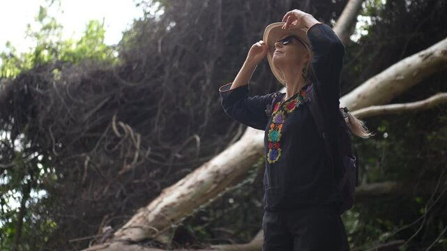 A smiling woman enjoys her journey through the vibrant jungles of Charco Verde Reserve on Ometepe Island. Her happiness reflects the beauty of the surroundings.