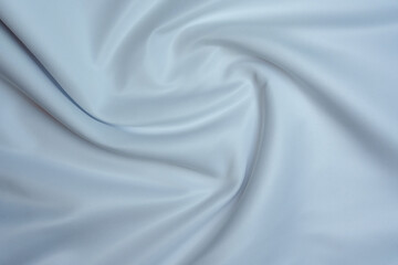 Obraz premium Soft white fabric with smooth folds and swirl pattern