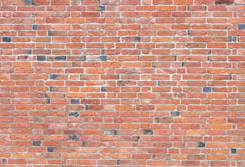 A red brick wall during the renovation of a farm building with signs of having been repointed