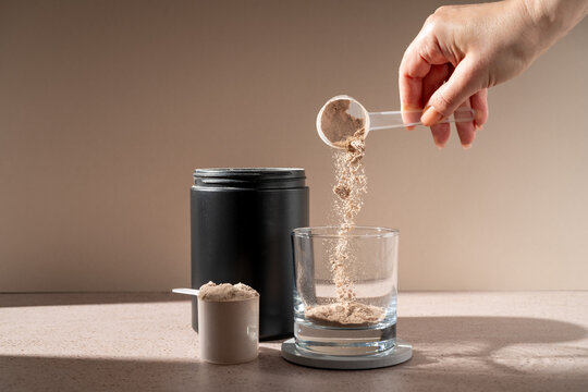 Chocolate protein powder in a scoop, food supplement