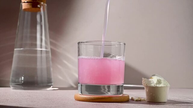 Protein shake and strawberry protein powder in a scoop, collagen, creatin, food supplement