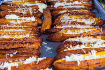 Plantain stuffed and fried. Ecuadorian food of baked ripe banana stuffed with cheese. Baked ripe stuffed banana. Traditional dish plantain canoe. Hot fried plantain slices, picnic style