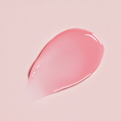 Pink lip gloss, lip tint, or hydrating serum swatch with a smooth glossy texture on a soft pink background.ﬁ