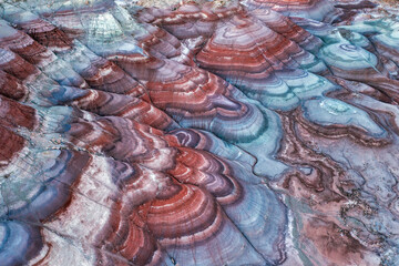 Aerial view of the Bentonite Hills during the blue hour after sunset showing the multi-colored layers of clay and sediment near the Mars Desert Research Station near Hanksville, Utah.