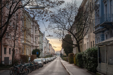 Typical street of Graz center in Austria, quiet residential street with austrian facades & parked bicycles illustrates the city architectural charm, real estate appeal, & leisurely Austrian lifestyle.