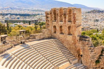 Naklejka premium A stone building with a , the Acropolis of Athenslarge stone archway and a stone balcony