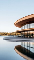 Circular lakefront building; calm water reflection; autumn trees; architectural design