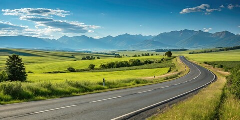 Fototapeta premium Scenic Road Ahead - Open Highway, Lush Countryside, and Clear Blue Sky for Travel and Adventure Enthusiasts