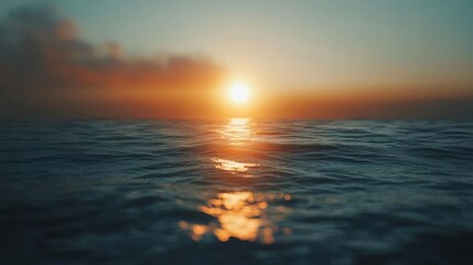 Fototapeta premium Sunset over the ocean with calm waves and warm colors