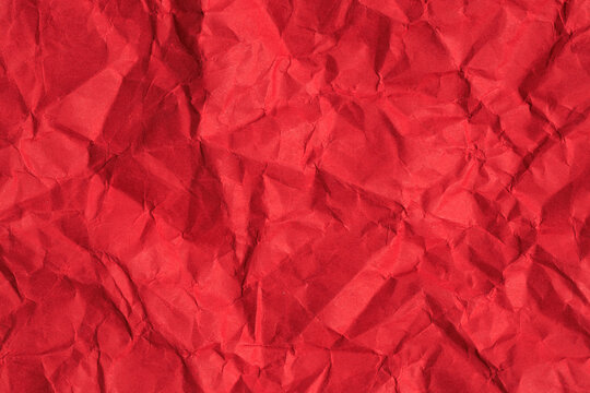 Textured red crumpled paper background with abstract pattern
