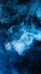 Obraz premium ethereal swirls of blue smoke against a dark background in vertical orientation