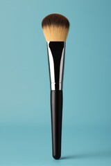 a close up of a large black brush with a white handle