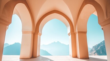 Fototapeta premium Serene architectural view of arches framing a mountain landscape under a clear blue sky
