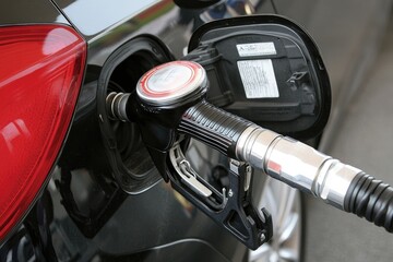 Fuel nozzle inserted into a car fuel tank