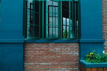 This modern style home interior image shows two windows in the warm living room, overlooking the view.
