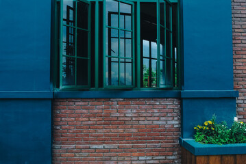This modern style home interior image shows two windows in the warm living room, overlooking the view.