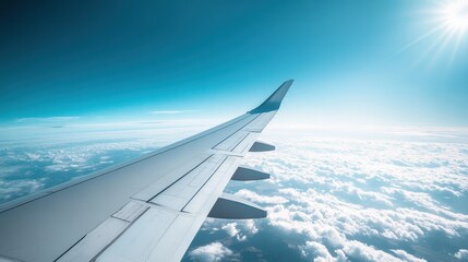Close-Up View of Airplane Wings Gliding Through a Clear Sky Above Fluffy Clouds