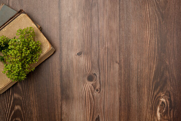 Vintage books with flowers on wooden background. Flat lay, top view. Copy space