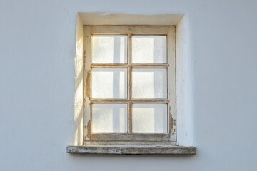 Obraz premium Distressed six pane window set in a bright white wall