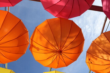 Colorful umbrellas hanging from the sky, emotional umbrellas
