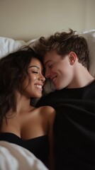 Mixed couple, Latina woman and white man smiling at each other in bed. Vertical photography (9:16)