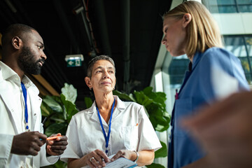 Medical team discussing patient care in hospital lobby
