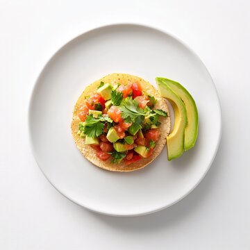 Delicious tostada with fresh avocado and tomato salsa on a white plate healthy and vibrant