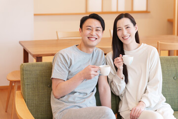 Fototapeta premium 朝起きてリビングでコーヒーを飲む夫婦