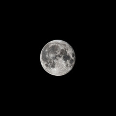 Detailed image of the full moon isolated on black.