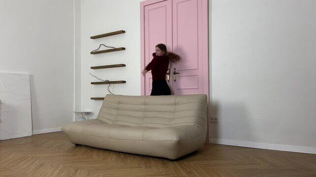 A dancer showcases a vibrant and engaging routine on a parquet floor in a stylish indoor area.