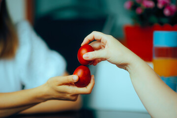 People Knocking Eggs at Family Easter Gathering. Family relaxing and following traditions during holidays
