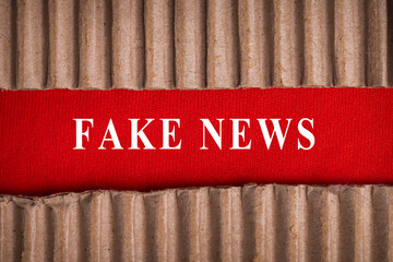 fake news words text message with cardboard on red background. fake news symbol concept copy space