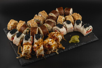 Sushi platter featuring diverse rolls and garnishes for a culinary experience